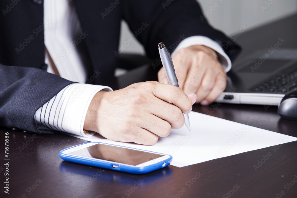 Business man's hands writing document Business man's hands writing document
