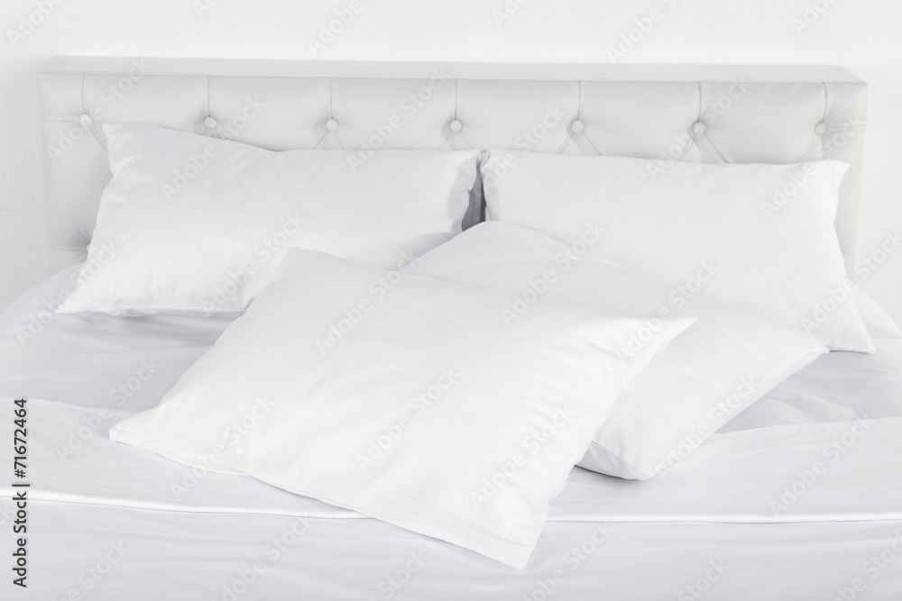 Fototapeta premium White pillows on bed in room
