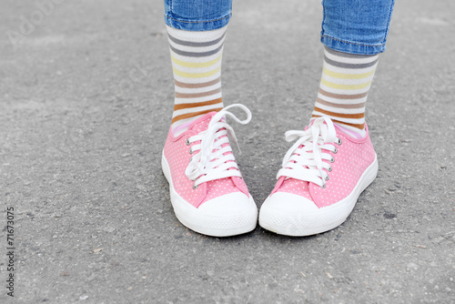Female legs in colorful socks and sneakers outdoors © Africa Studio