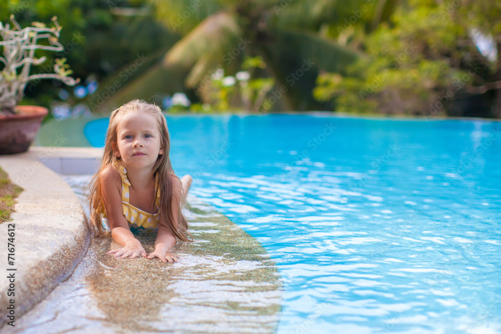 Little adorable girl in swimming pool relax outdoors