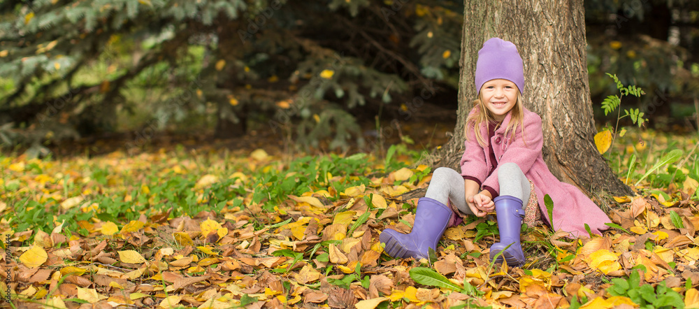 Little happy girl in autumn park outdoors Little happy girl in autumn park outdoors