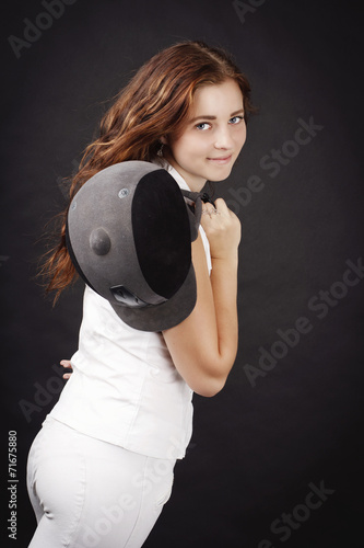 Beautiful young woman with showjuping helmet photo
