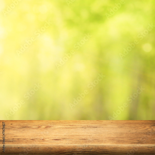wood table on green summer forest background © Andrey Kuzmin
