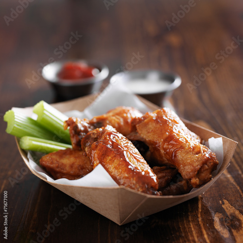 barbecue buffalo chicken wings with celery sticks