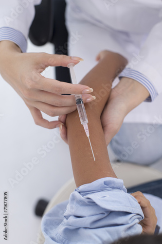 Children receive an injection in the arm