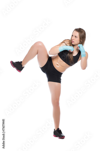 Young woman posing and kicking © Sergey Sukhorukov