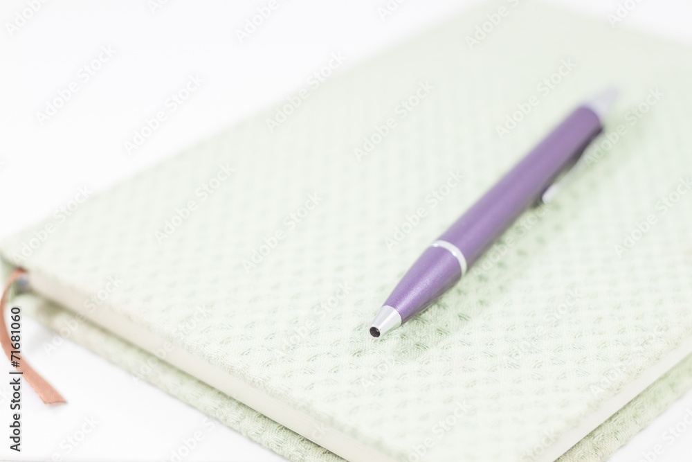 Closeup notebook with pen on white background Closeup notebook with pen on white background