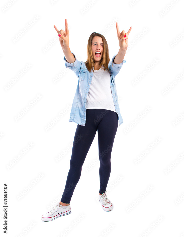Girl making horn gesture over white background Girl making horn gesture over white background