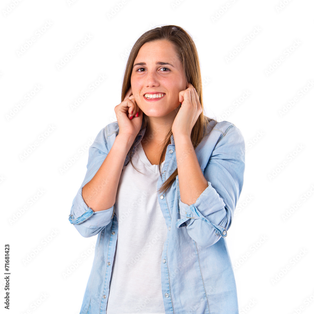 Girl covering her ears over white background Girl covering her ears over white background