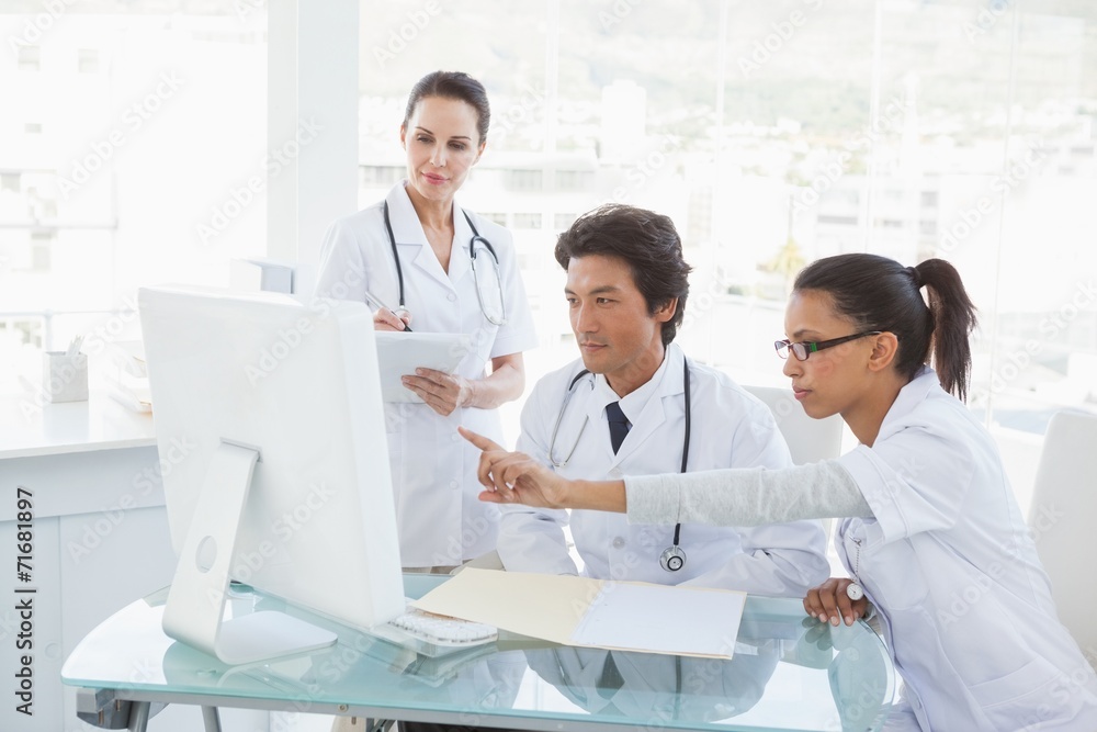 Doctors looking at the computer monitor Doctors looking at the computer monitor