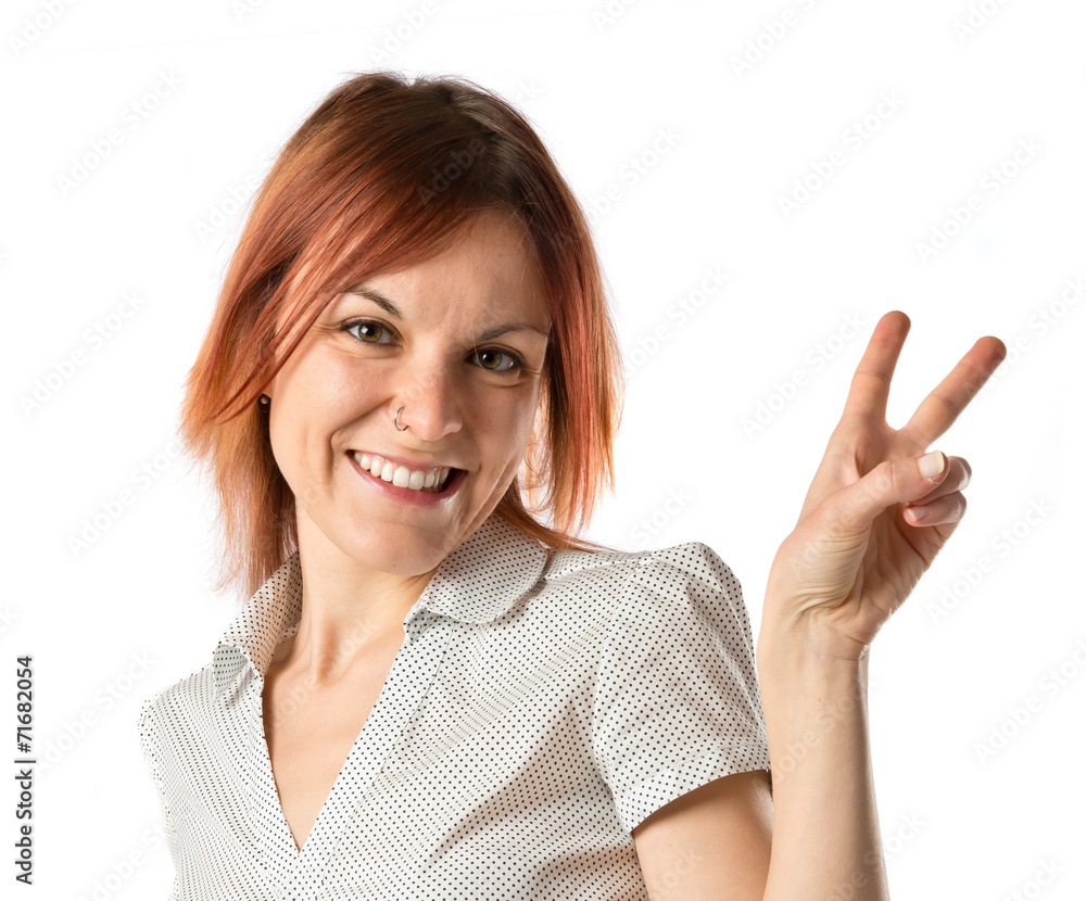 Girl doing victory gesture over white background Girl doing victory gesture over white background