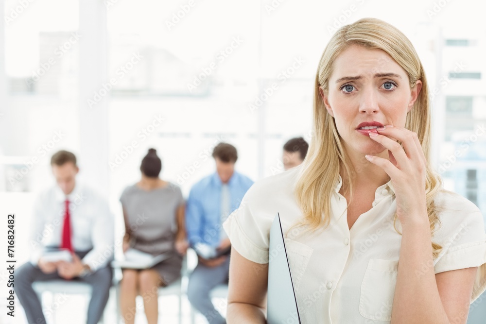 Businesswoman against people waiting for interview Businesswoman against people waiting for interview