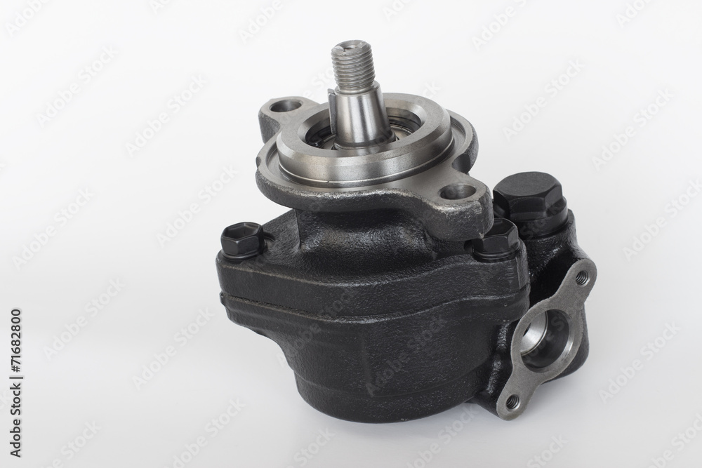 power steering pump on a gray background. engine parts power steering pump on a gray background. engine parts