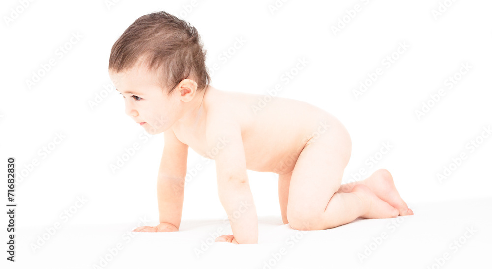 Child creeps on a white bed Child creeps on a white bed