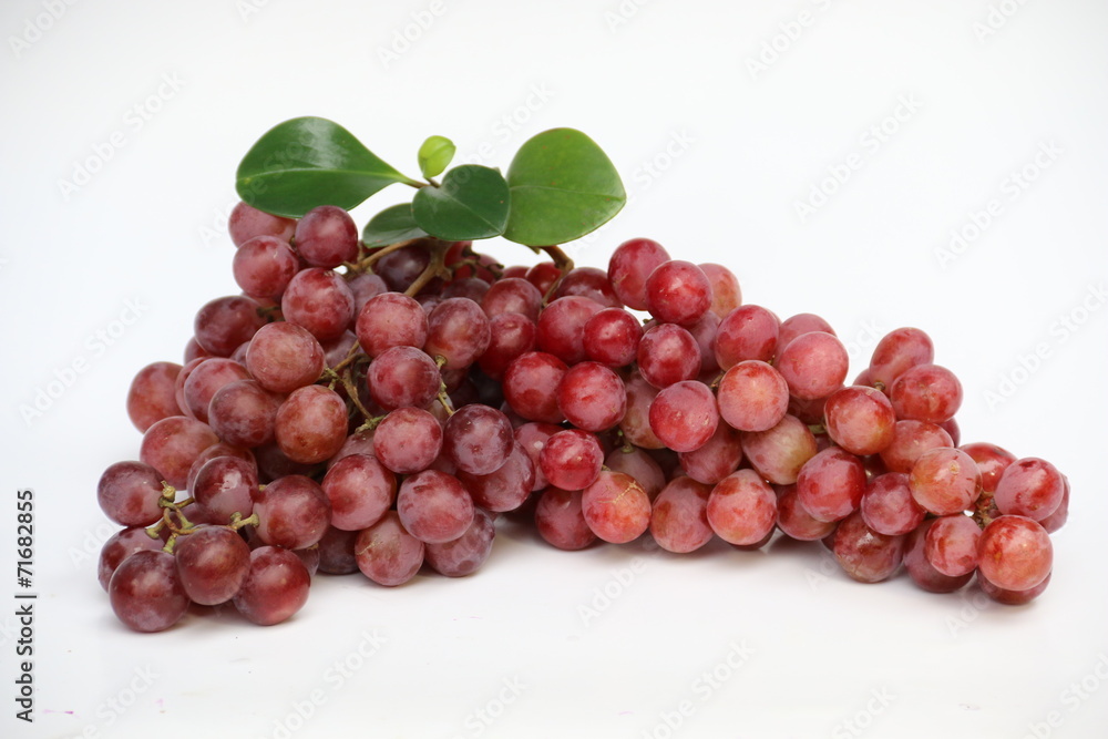 Red grapes with fresh leaves, isolated on white background