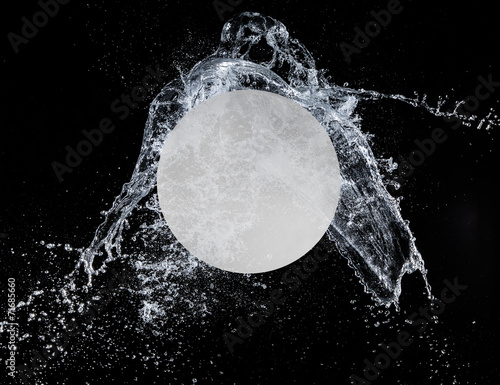 Sport ball with water splash on black background