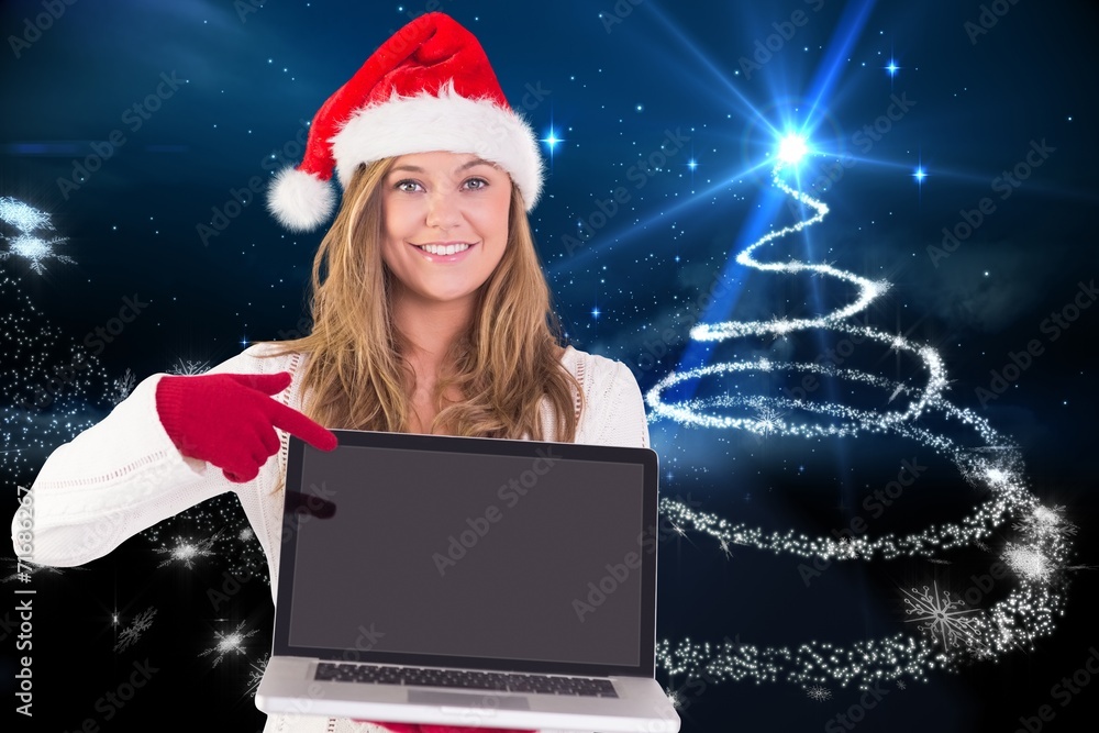 Composite image of festive blonde pointing to laptop Composite image of festive blonde pointing to laptop