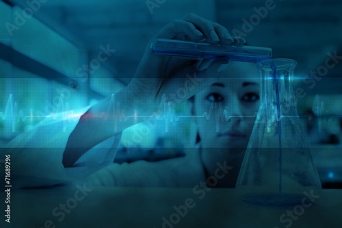 Fotografie Scientist pouring a liquid in an erlenmeyer