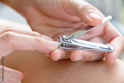 hand manicure with nail clipper