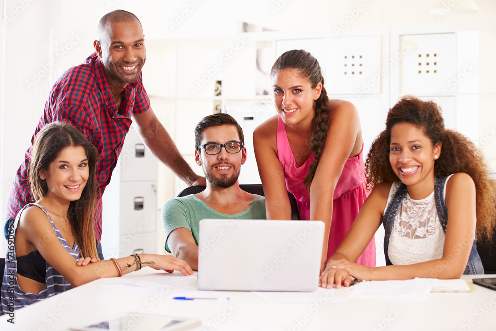 © Monkey Business - Businesspeople Using Laptop In Office Of Start Up Business