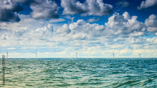 wind turbines power generator farm along coast sea