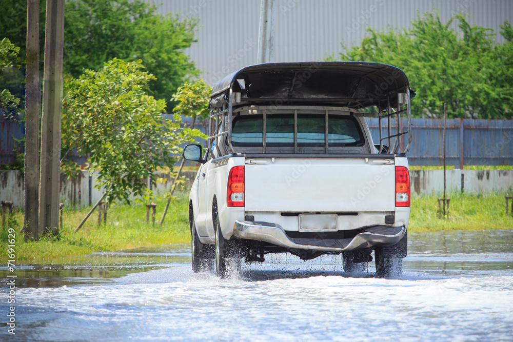 Splash by a car as it goes through flood water