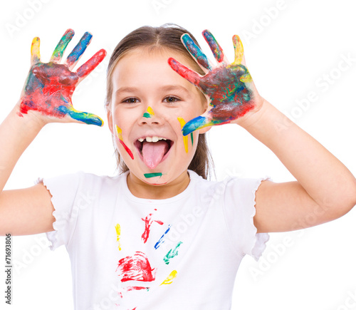 Cute girl playing with paints