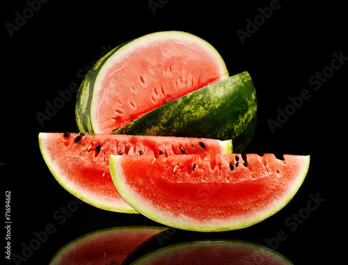 Studio shot whole and slice of watermelon isolated black