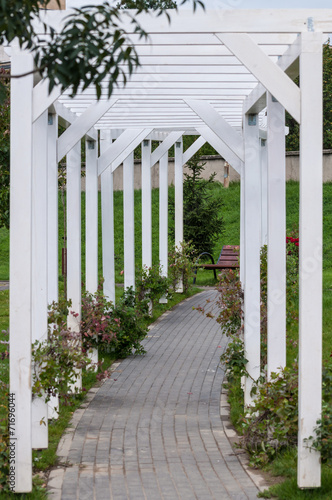 wooden arch tunnel at the entrance of a garden