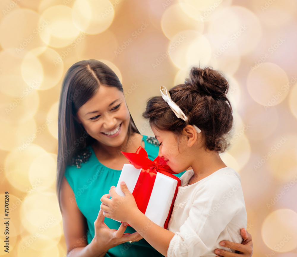 happy mother and little girl with gift box happy mother and little girl with gift box