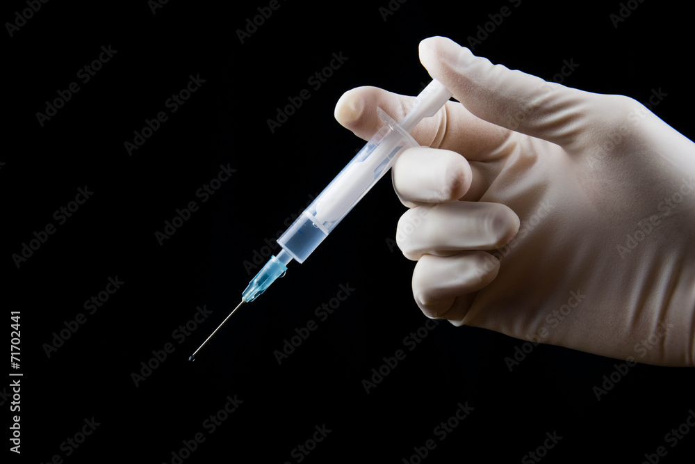 Syringe in hand Syringe in hand