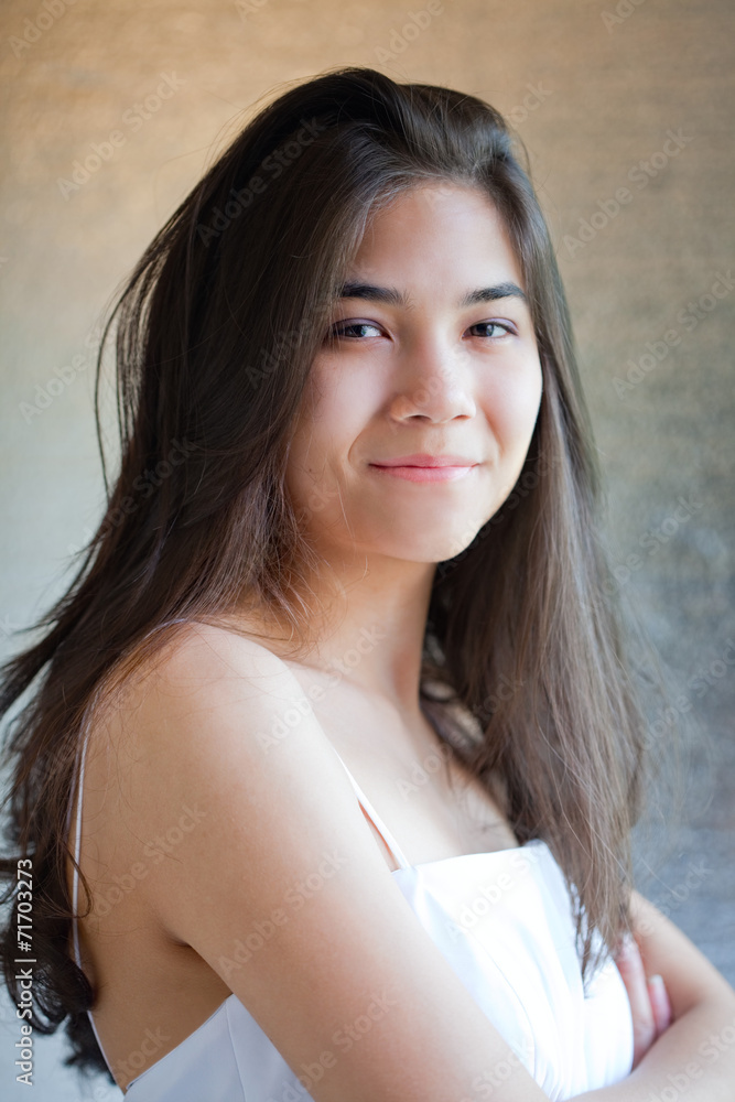 Biracial teen girl in white gown, arms crossed Biracial teen girl in white gown, arms crossed