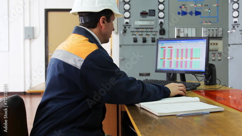 engineer works on computer sitting at desk, close-up