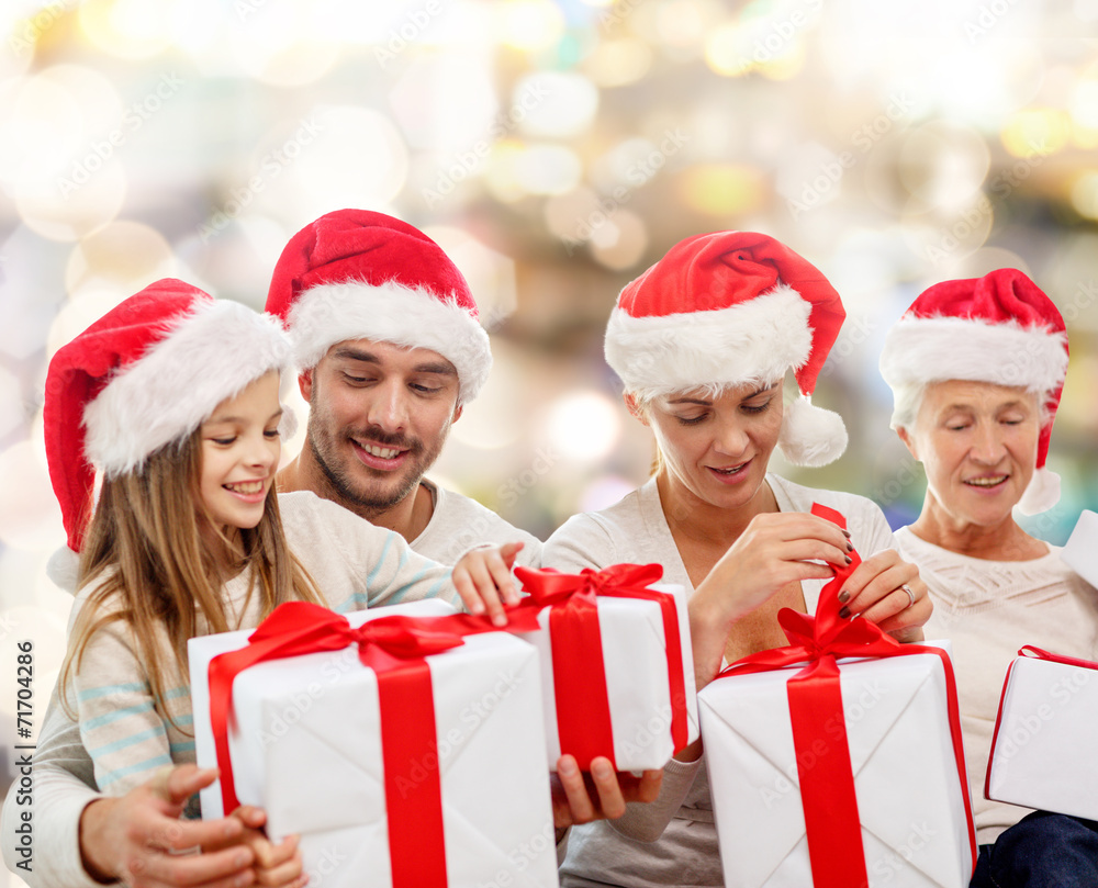 happy family in santa helper hats with gift boxes happy family in santa helper hats with gift boxes