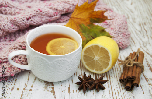 Cup of hot tea with lemon and scarf