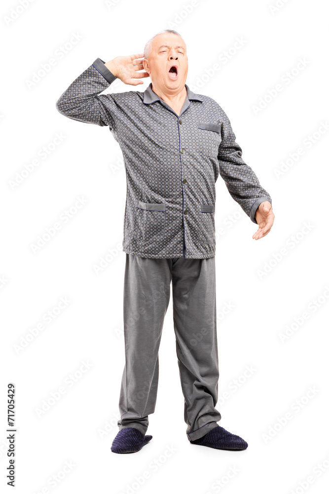 Sleepy senior in pajamas stretching Sleepy senior in pajamas stretching