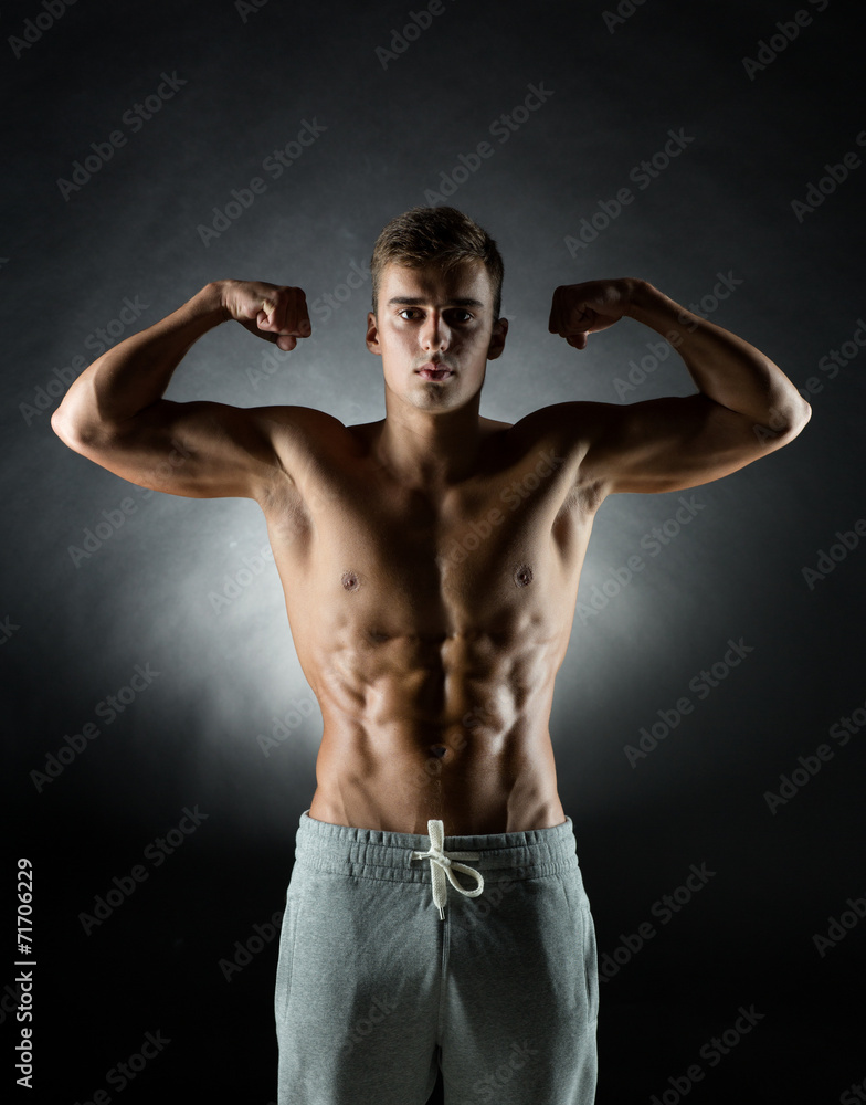 young man showing biceps