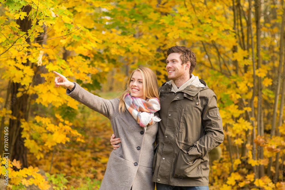 Fototapeta premium smiling couple hugging in autumn park