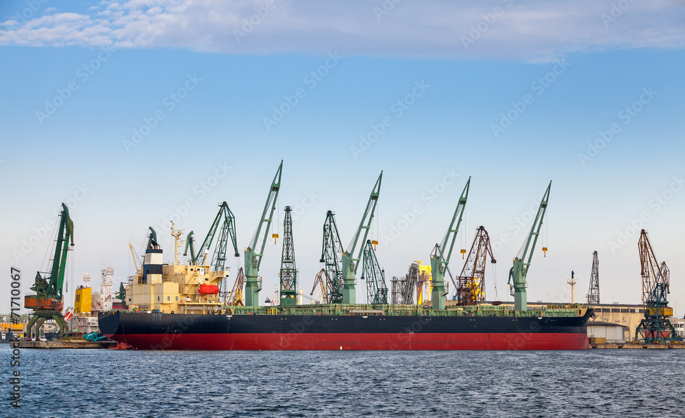 Loading with cranes of big industrial cargo ship in Varna port