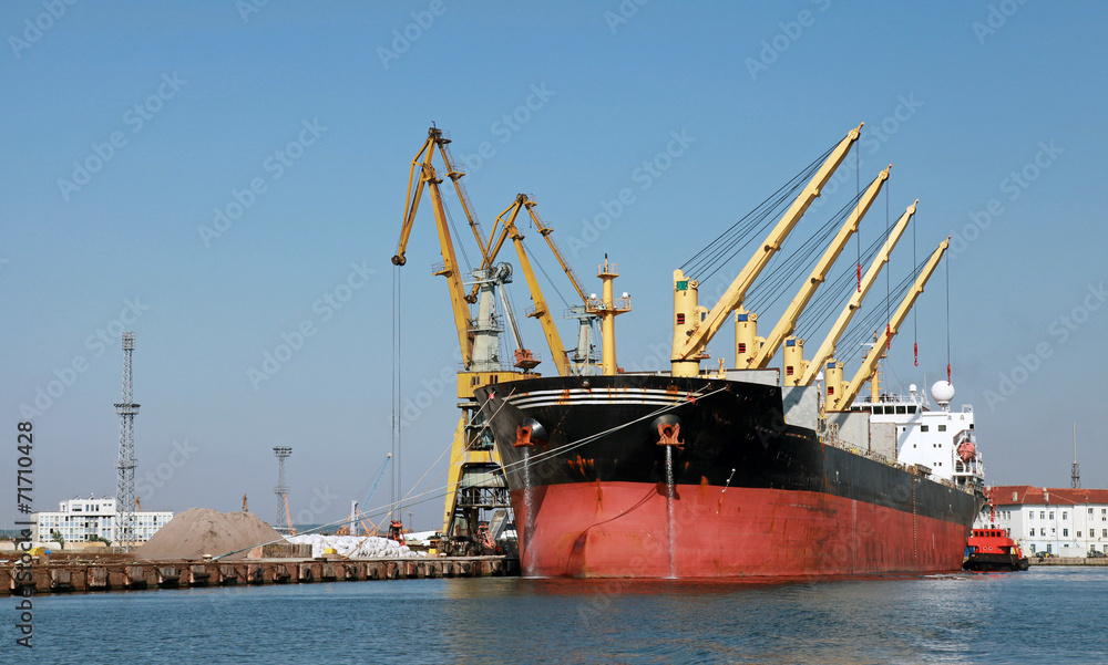 Loading with cranes of big industrial cargo ship in Burgas port