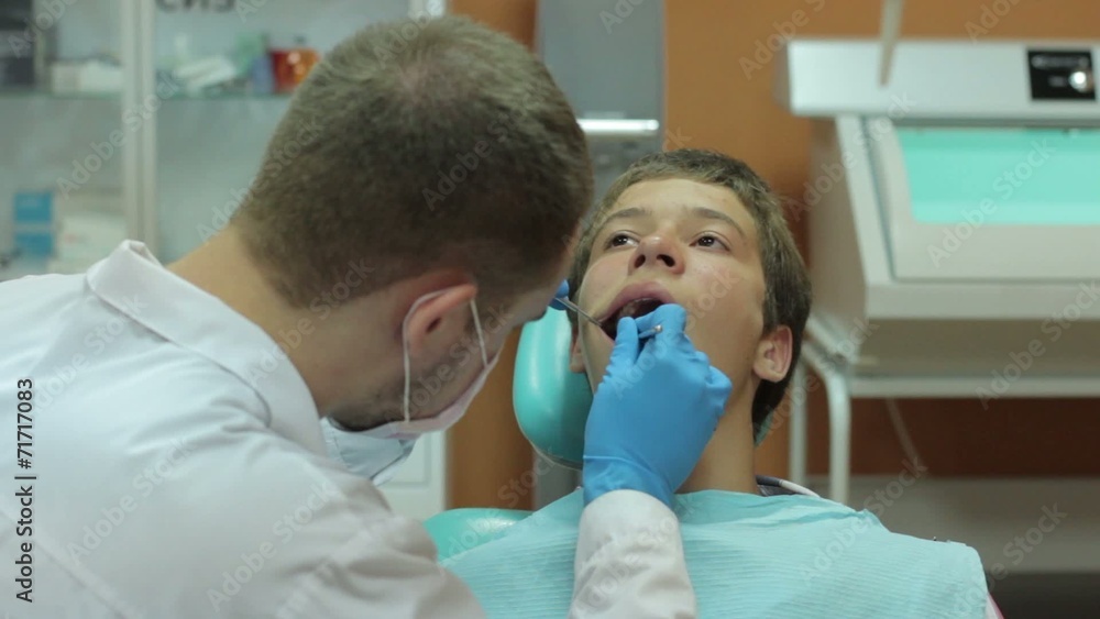 Dentist carry out routine inspection of the patient Dentist carry out routine inspection of the patient