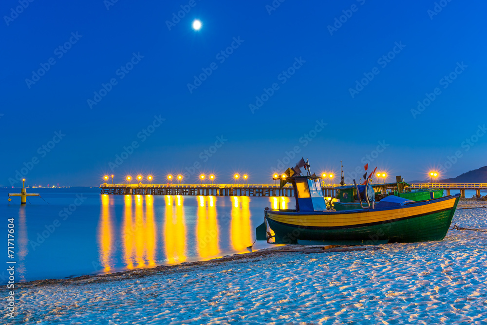 Fototapeta premium Baltic beach with fishing boat at night, Poland