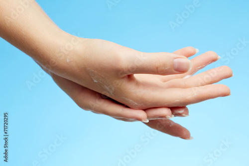 Woman's hands in moisturizer cream