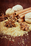 Anise star with cinnamon sticks and walnuts on brown cane sugar