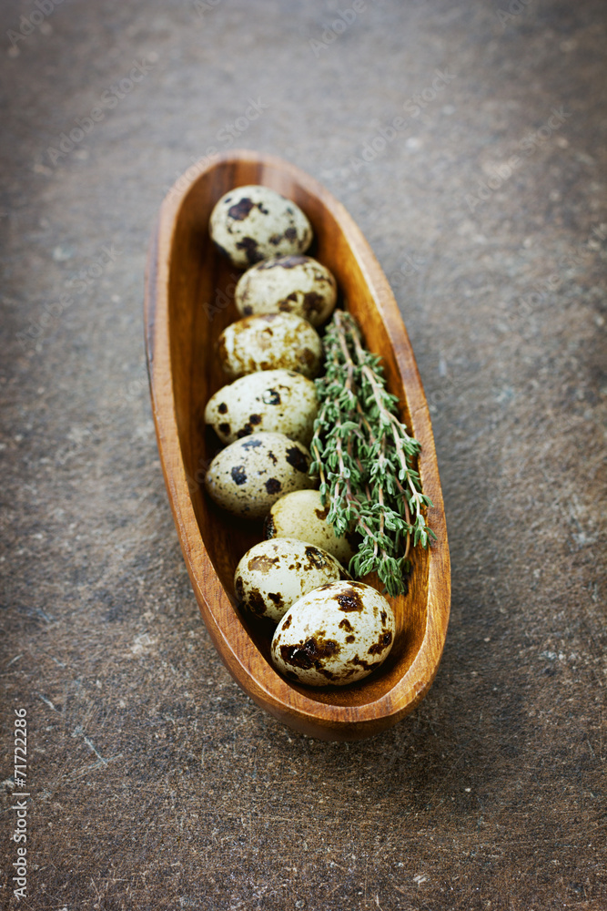 Quail eggs with a thyme in a wooden cup Quail eggs with a thyme in a wooden cup