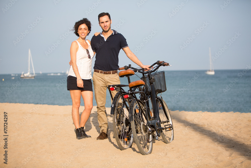 Paar mit Fahrrädern auf einem Stadtstrand