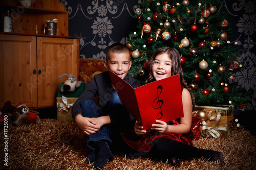 Little children singing a song at Christmas Eve
