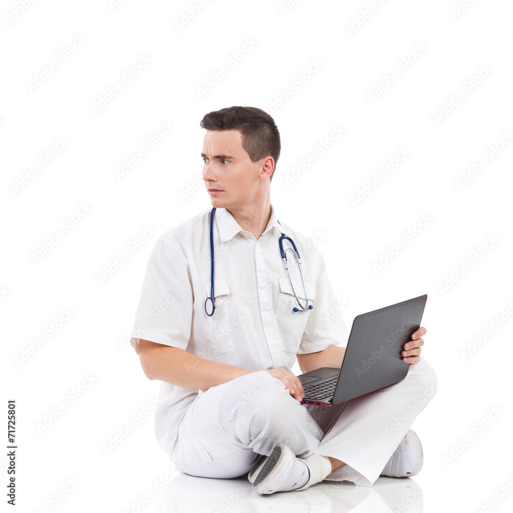 Serious male medicine student with a laptop Serious male medicine student with a laptop