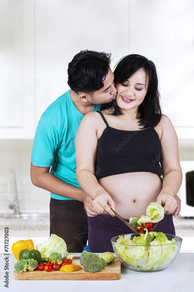 Husband kiss his wife in kitchen Husband kiss his wife in kitchen
