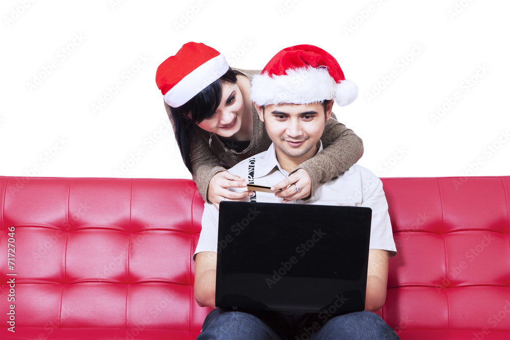 Isolated christmas couple shopping online Isolated christmas couple shopping online